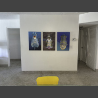 Queen Triggerfish Attack - 30x20 a trio of whimsical Fish Faces photographs hangs in a hallway