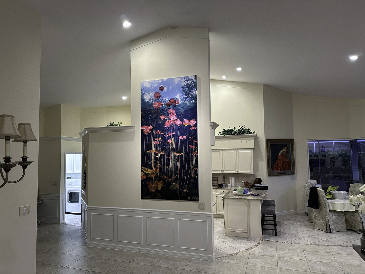 a large underwater photograph of lily pads hangs in a living room