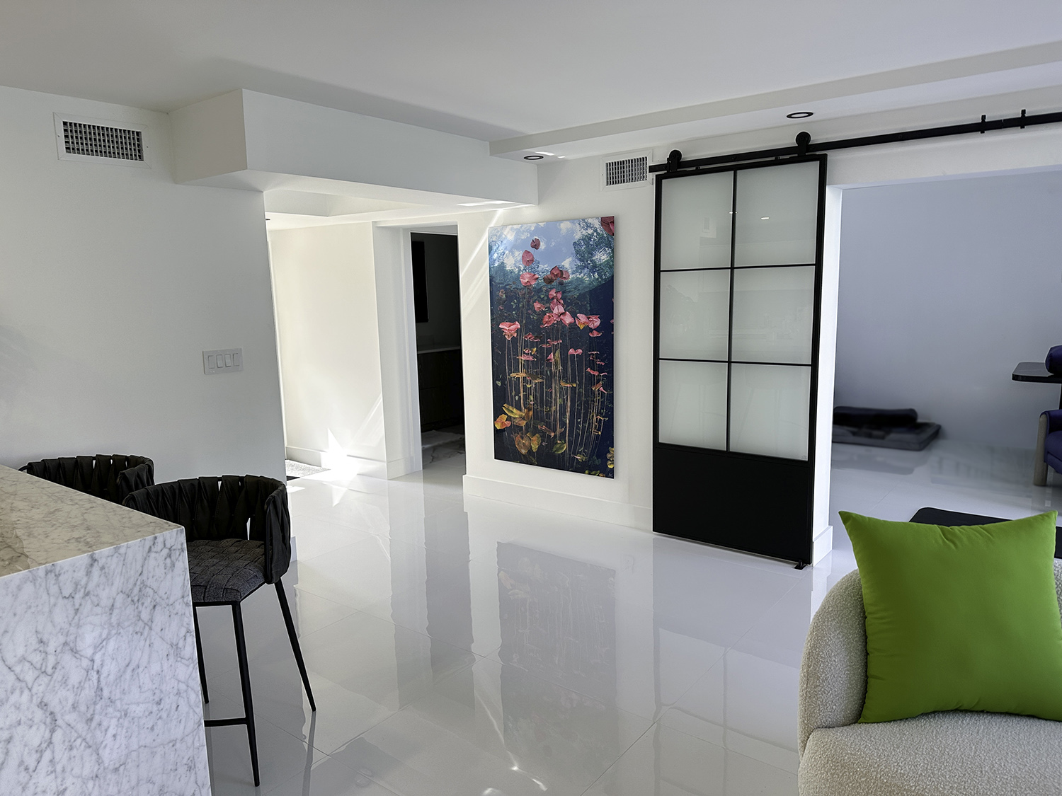 a large underwater photograph of lily pads hangs in a living room