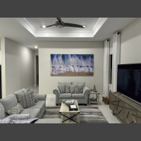 Riptide 96x48 in Living Room a large aerial photograph of waves crashing on a sndy beach is art above a couch