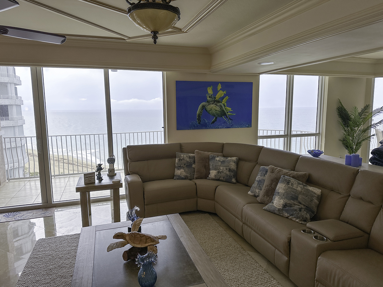 large art photograph of a green sea turtle being cleaned by yellow tangs, decorates a living room