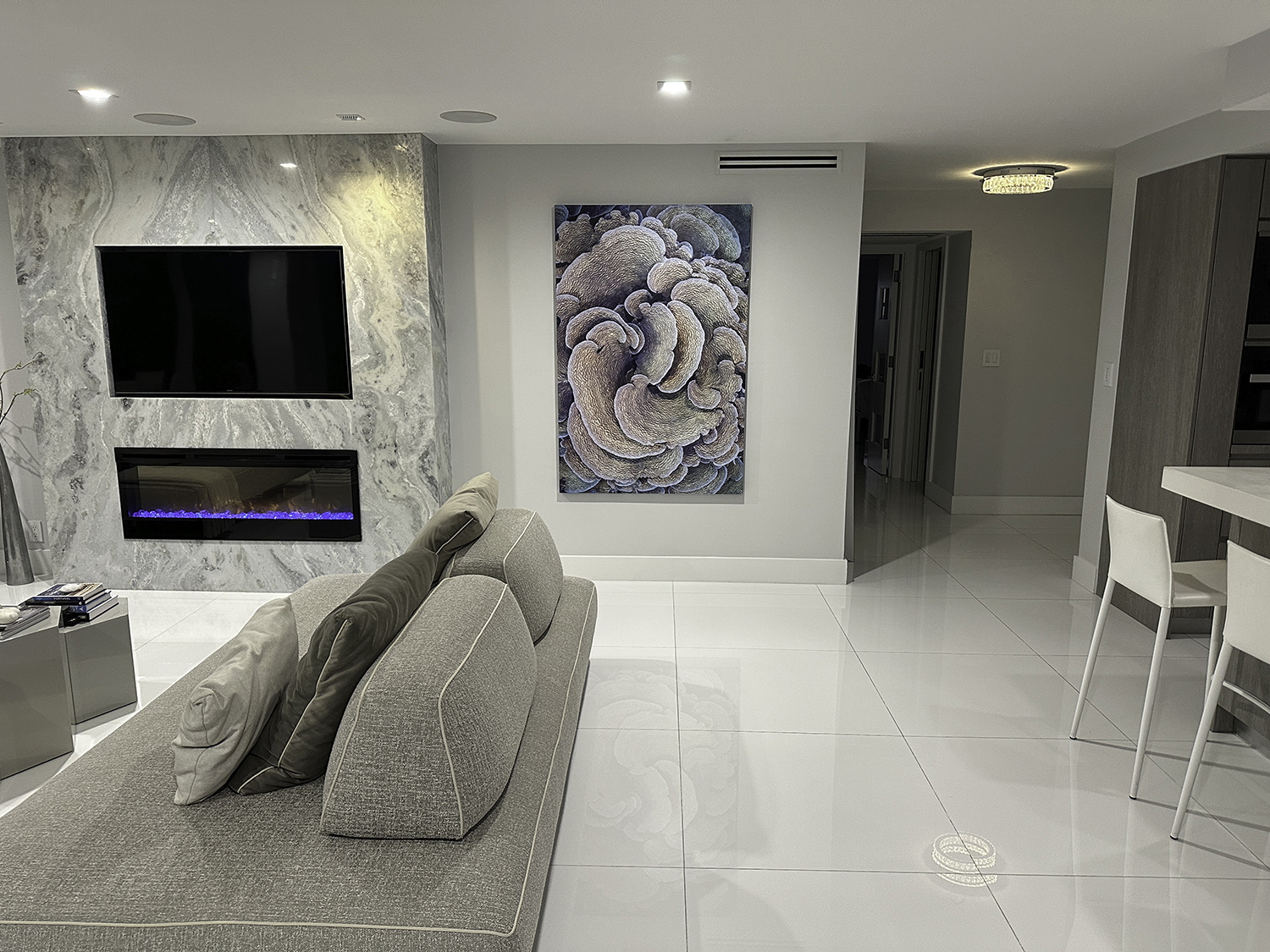 large underwater abstract art photograph of a cabbage coral is hung in a living room