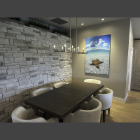 large art underwater photograph of a starfish in shallow water over white sand, displayed above a dining room table