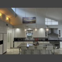 large art photograph of a beach at sunrise, displayed up above kitchen counters