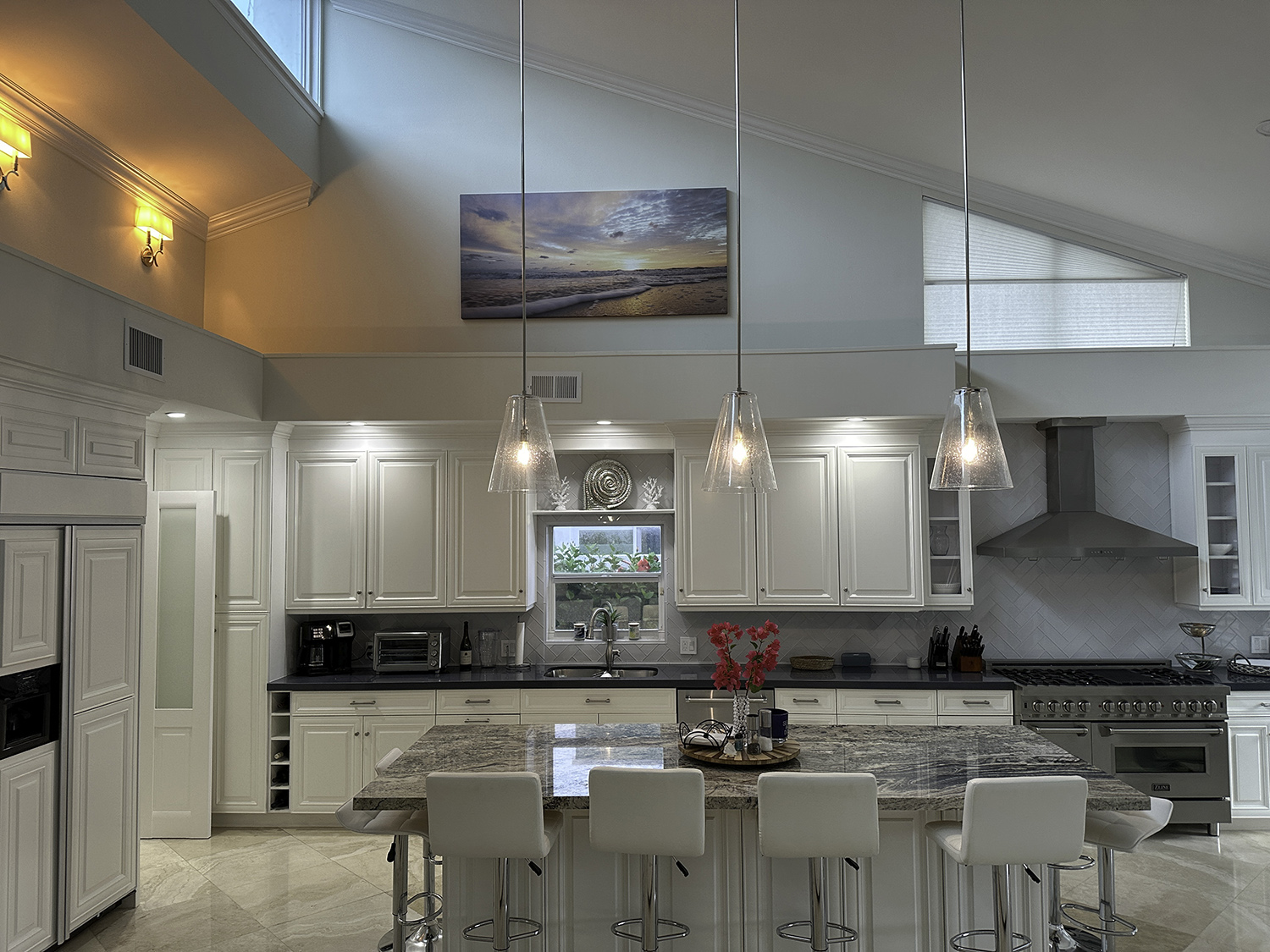 large art photograph of a beach at sunrise, displayed up above kitchen counters