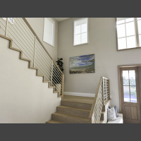 a large art underwater photograph of a wave from underneath, displayed on a staircase