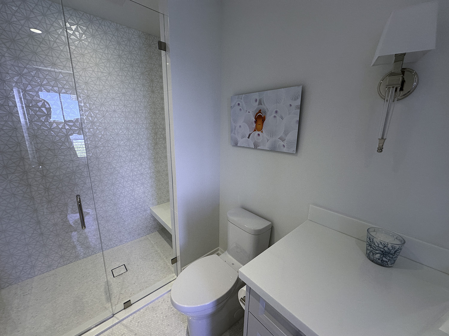 fine art underwater photograph of a clownfish in a white anemone, displayed in a bathroom