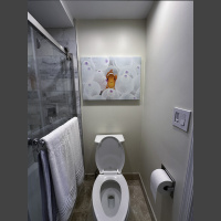 fine art underwater photograph of a clownfish in a white anemone, displayed in a bathroom