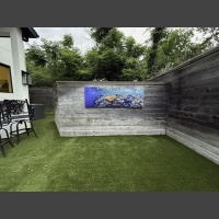 large fine art underwater photograph of a wall of coral, displayed outdoors on a privacy wall