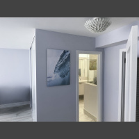 fine art underwater photograph of aan ocean wave, displayed in a hallway