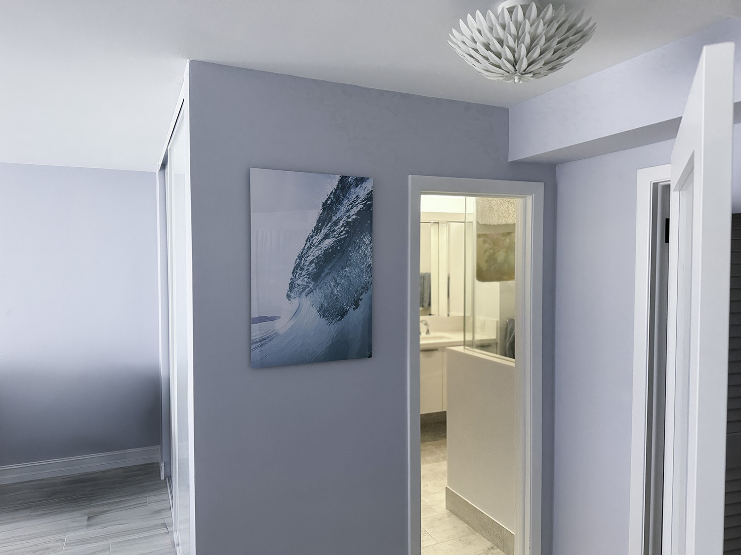 fine art underwater photograph of aan ocean wave, displayed in a hallway