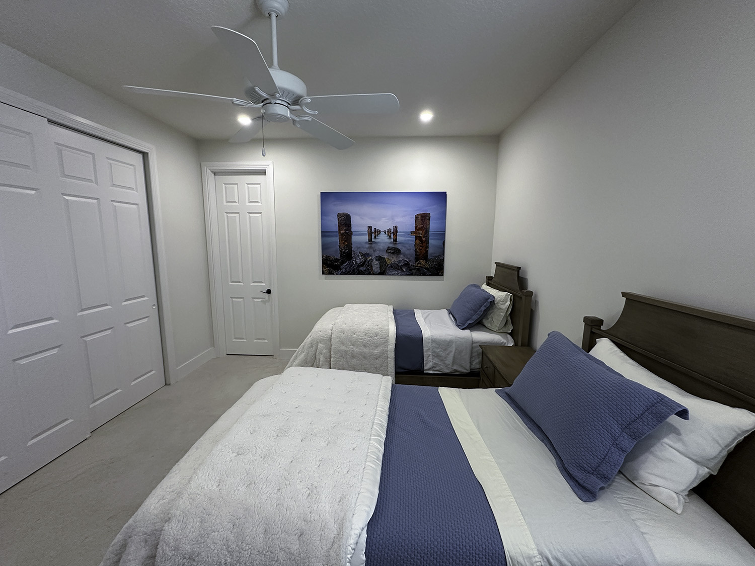 large fine art underwater photograph of an old broken pier, displayed in a guest bedroom