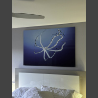 underwater photograph of a mimic octopus hangs above a bed